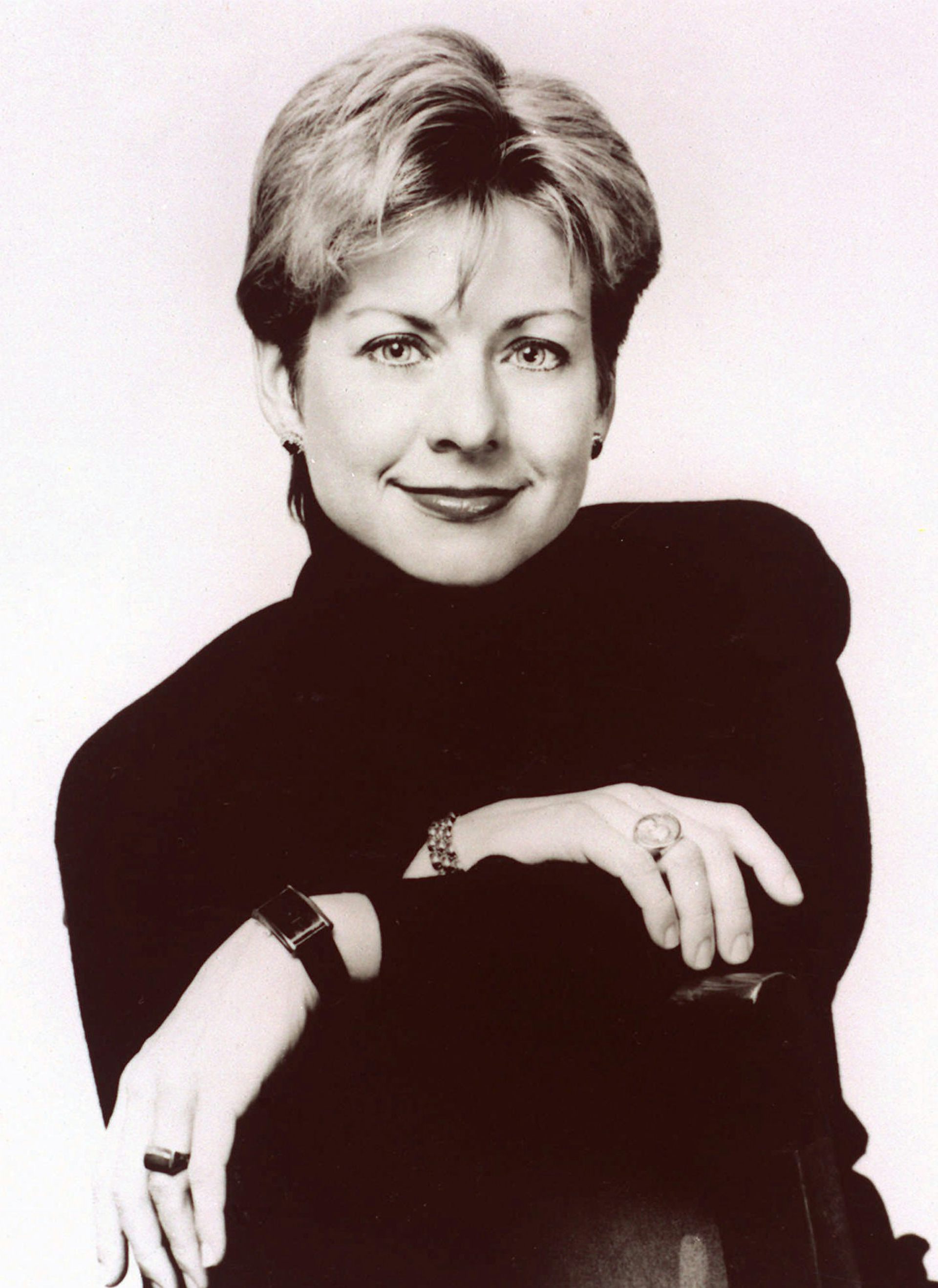 a smiling blonde woman in black