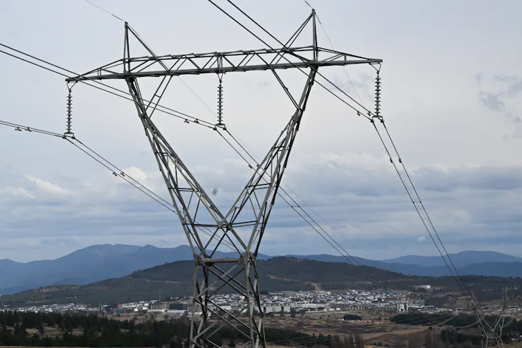 power lines, town behind them.