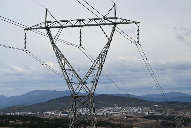 power lines, town behind them.