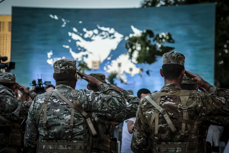 Argentinian soldiers at the inauguration of a monument commemorating the 'illegal occupation' of what they refer to as Las Islas Malvinas.