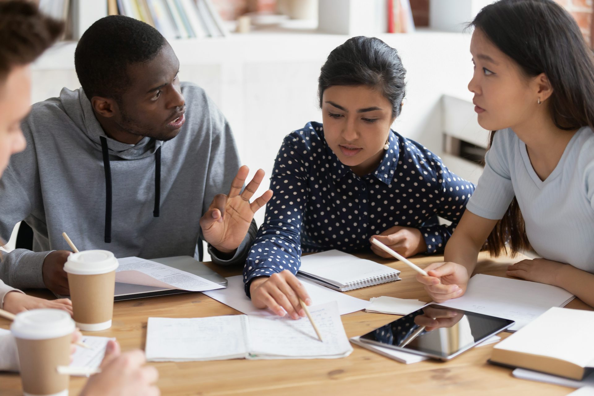 Three racially diverse students talking.