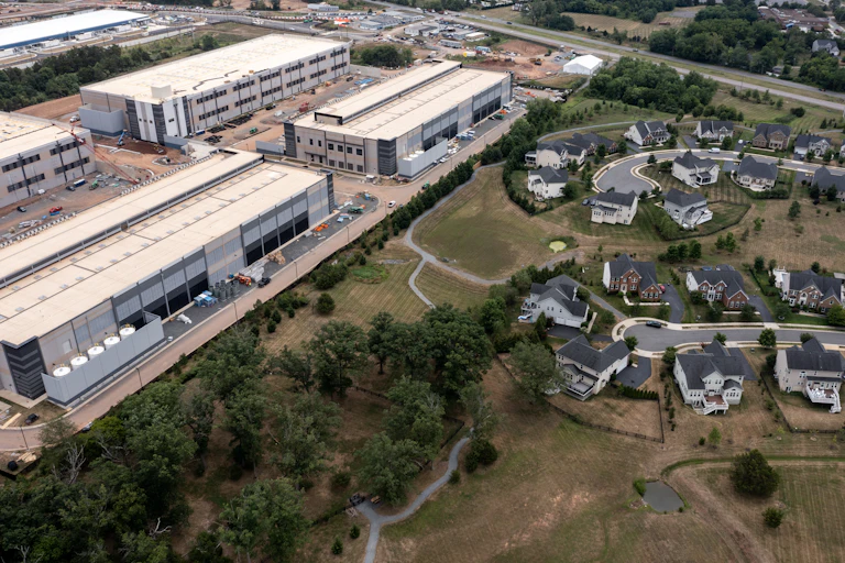 Large commercial or industrial buildings sit in rows near homes that line residential roads.