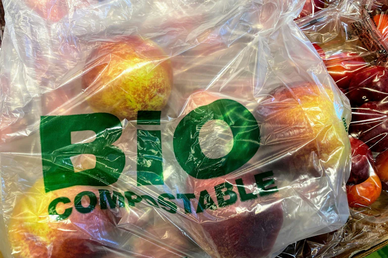 Apples in a plastic bag labelled "BIO COMPOSTABLE"