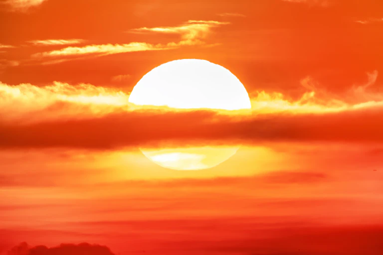 burning red sun and clouds.