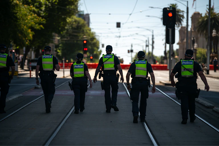 Police walk up to a blockade as a rally continues in Melbourne in 2026.