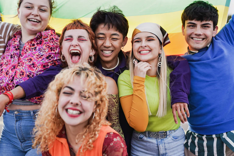 Group of happy young people having fun together during LGBT pride parade