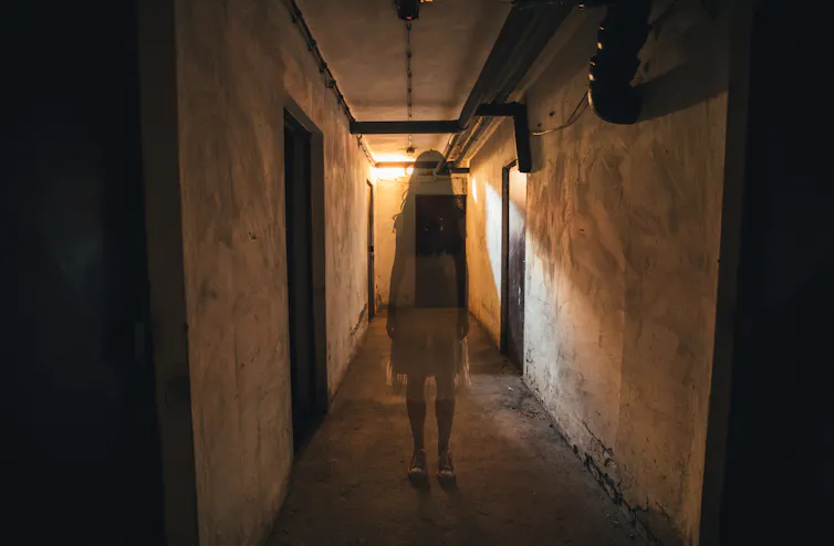 transparent outline of a girl in a creepy hallway
