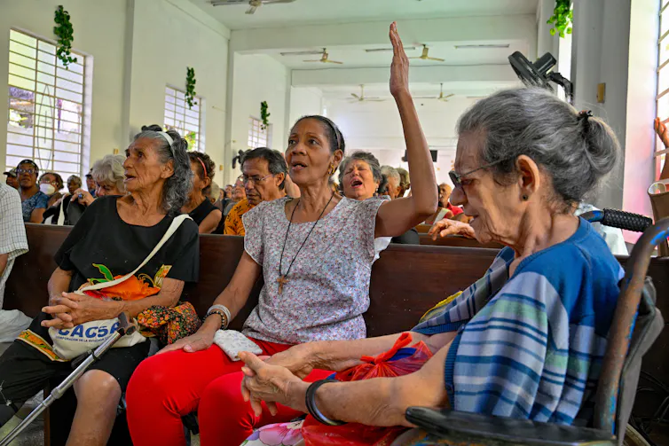 People attend a church service in an informal setting.