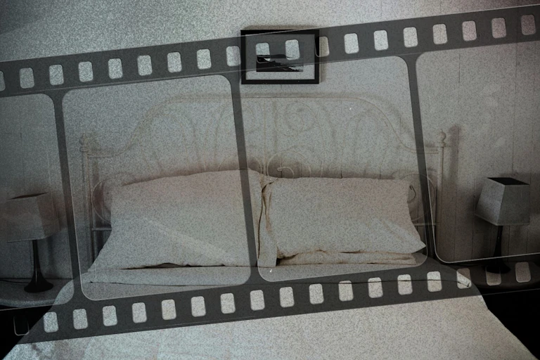 An empty bed with film stock overlayed