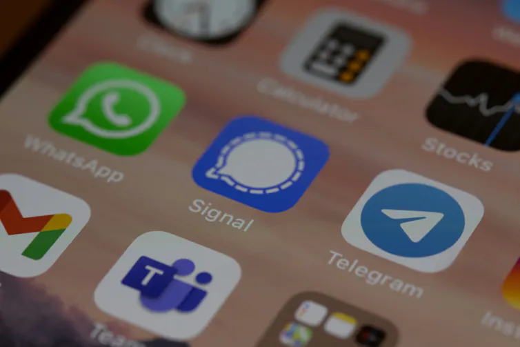 A close-up of a smartphone screen with the Telegram app, among others
