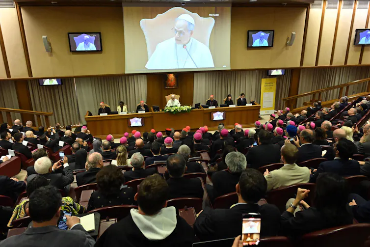Pope Leo presents the encyclical alongside his panel, in front of a packed audience.