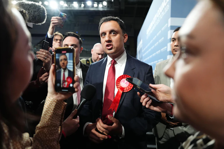 scottish labour leader anas sarwar surrounded by press as results come out in the 2026 parliamentary election.