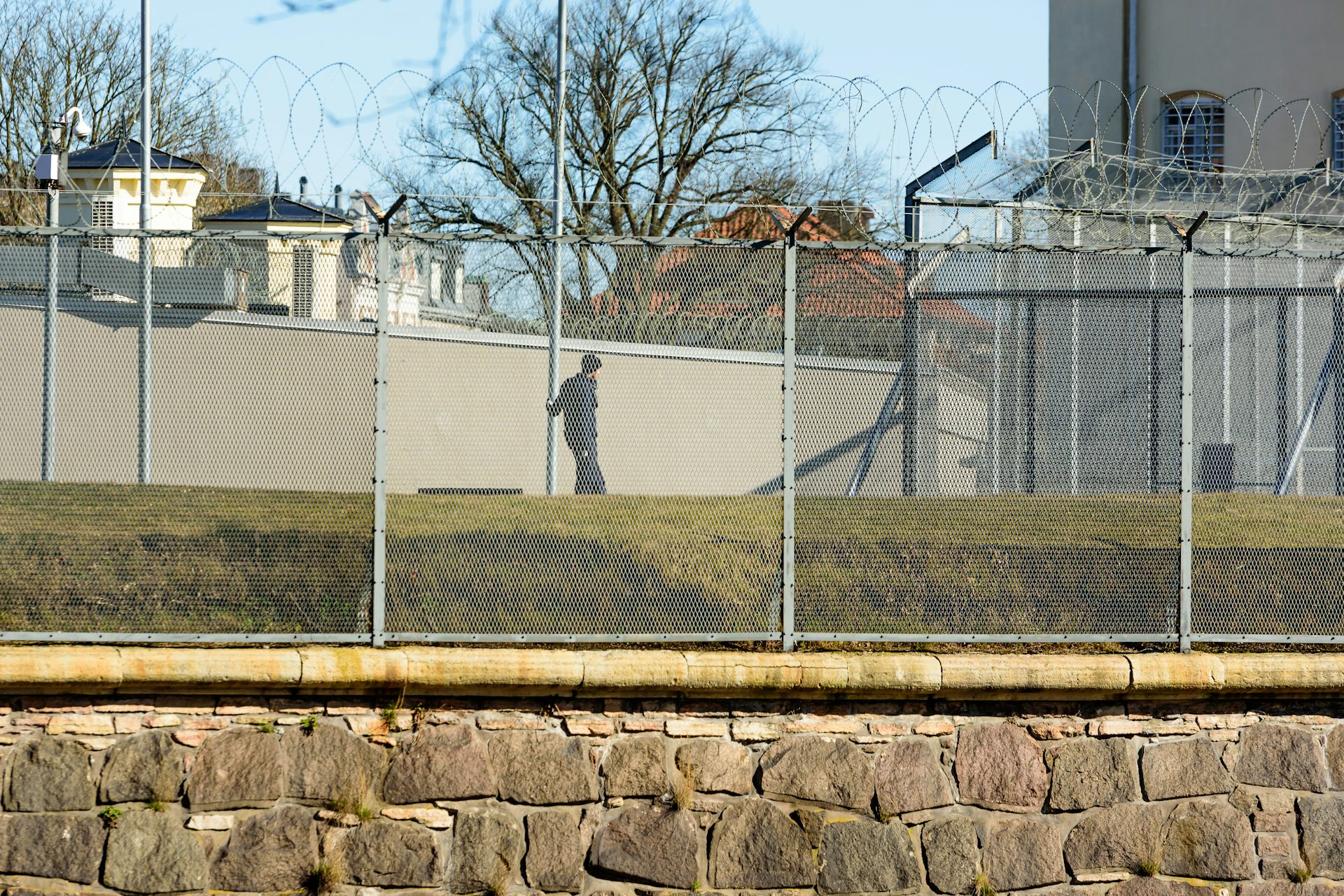 Man in prison exercise yard.