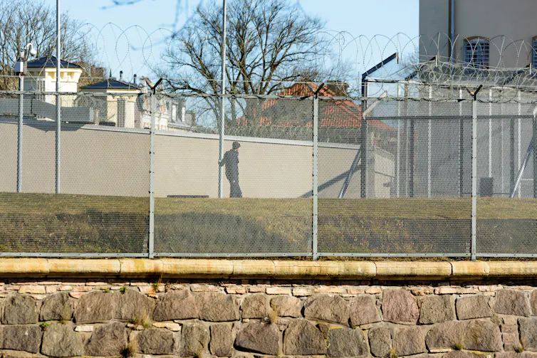 Man in prison exercise yard.