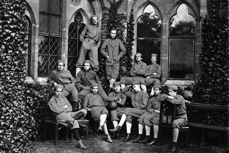 Members of a sports team in an old black and white photo.