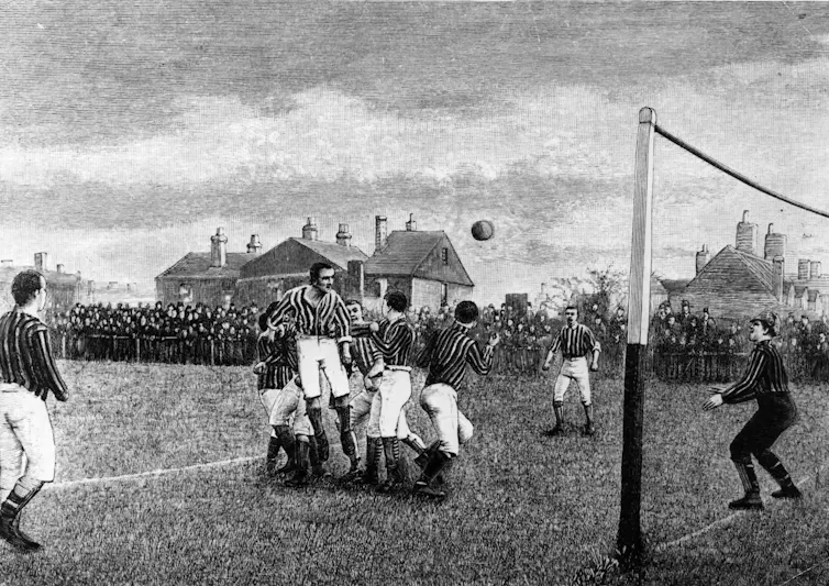 An old photo of a soccer match in progress.