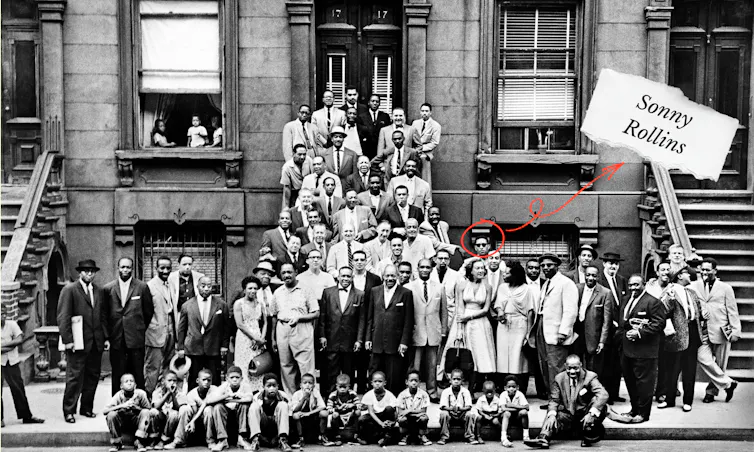 Sonny Rollins among many jazz musicians outside a brownstone in New York.