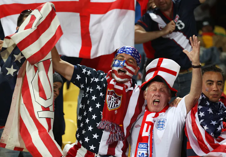 Soccer fans in English and USA garb celebrate together.