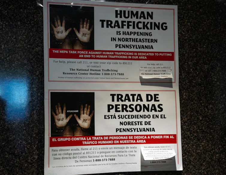 A poster shows a person's hands next to the words 'human trafficking.'