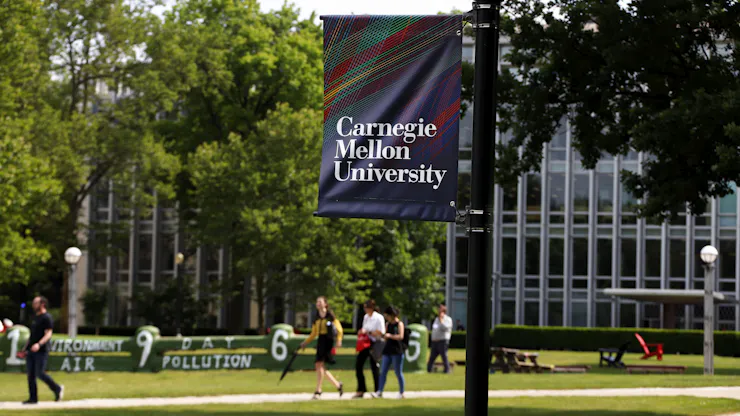 A sign on a lampost reads 'Carnegie Mellon University.'