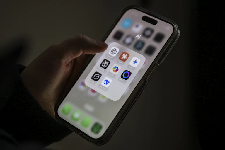 A phone with several AI apps in a folder labeled AI