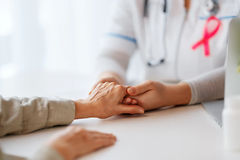 A medic holding a patient's hand.