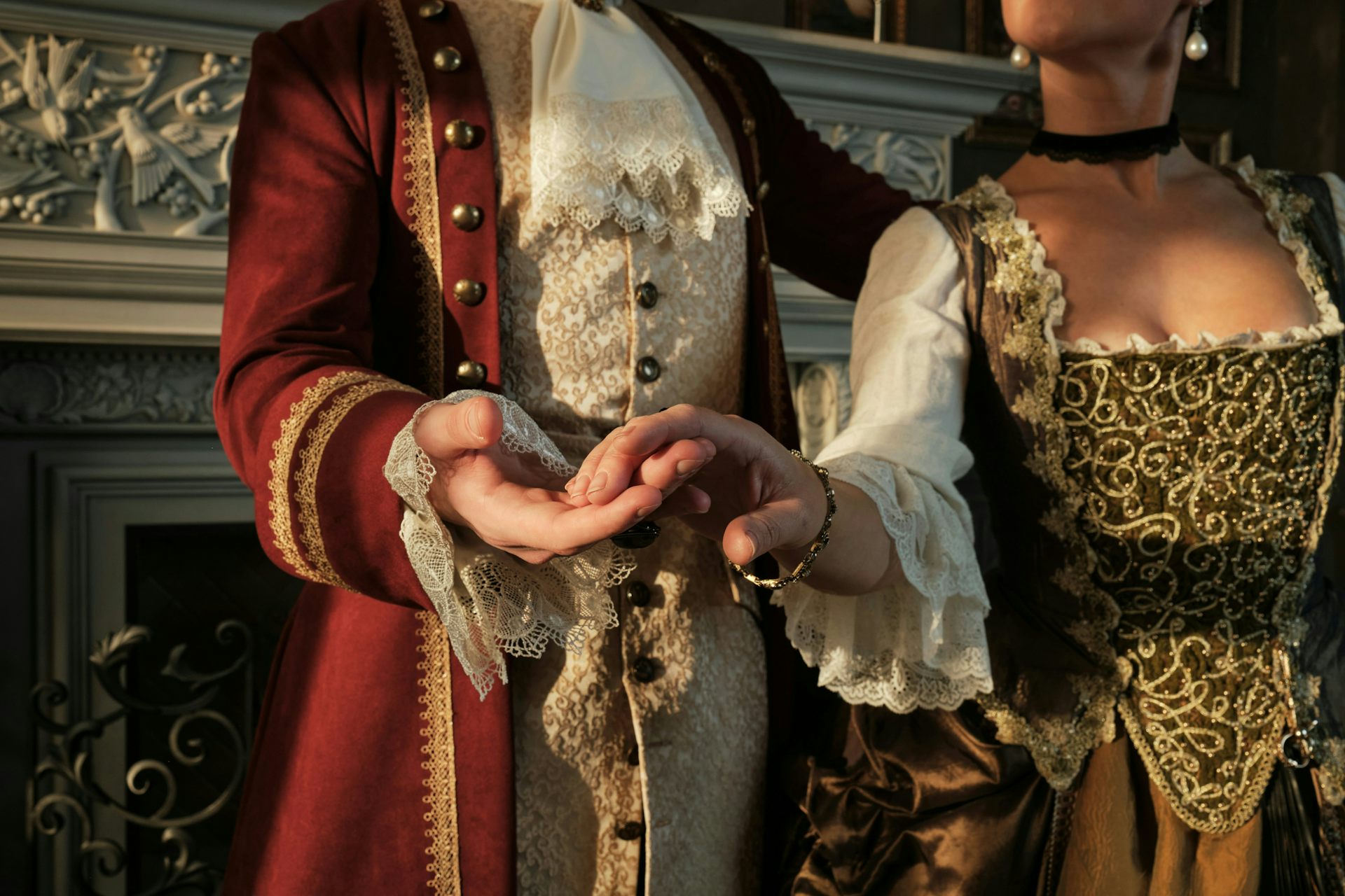 A couple, dressed in Regency era clothing, are dancing.