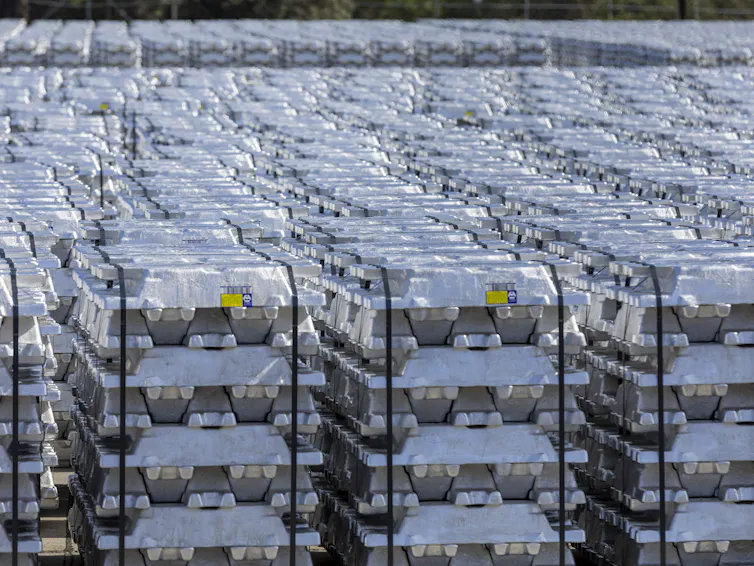Stacks of aluminium bricks in a row.