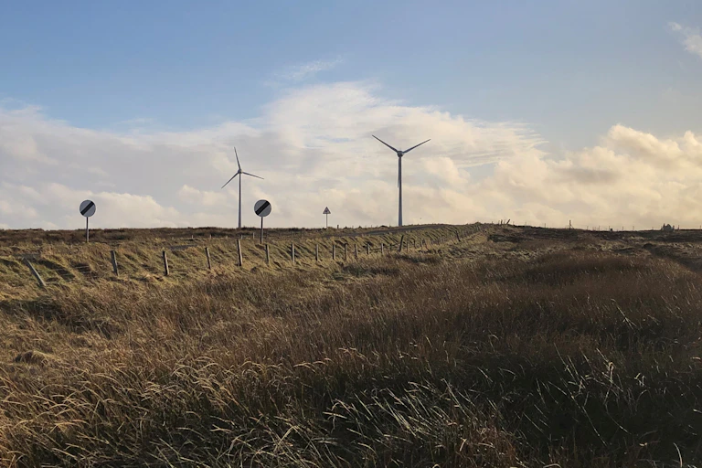 scottish landscape with wind turbines, blue sky