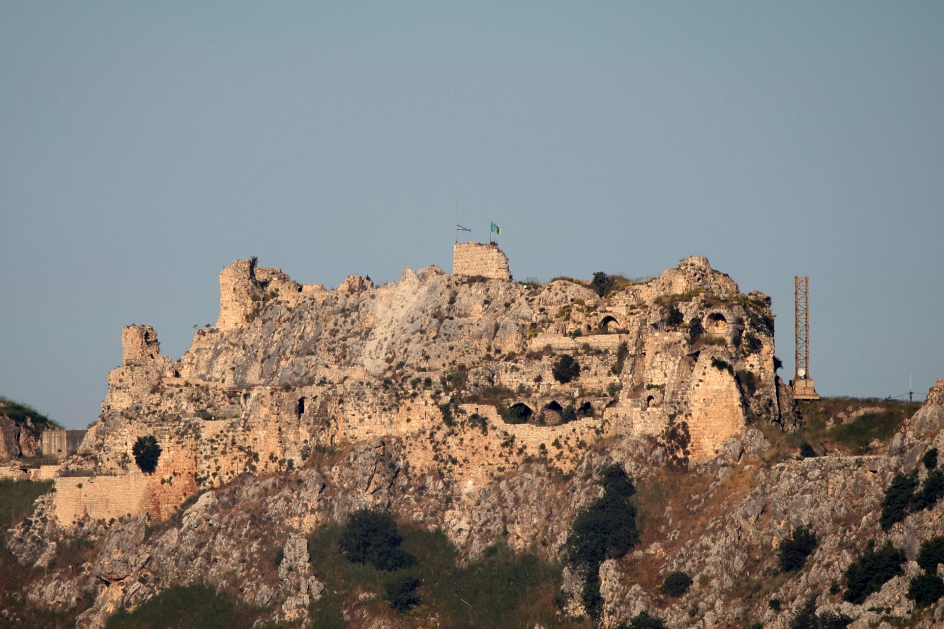 An old castle fortification stands atop a hill.