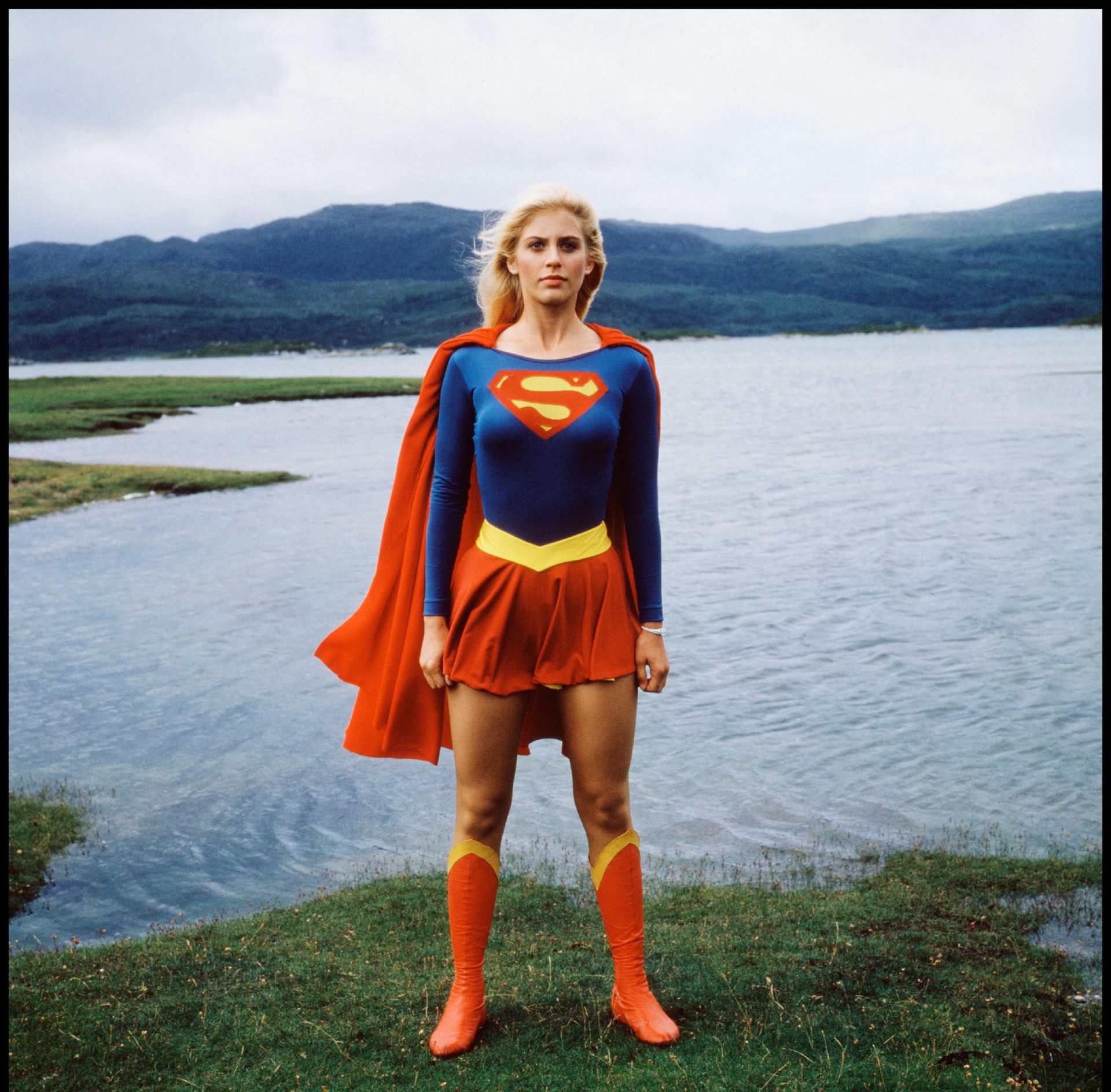 Helen Slater as Supergirl standing by a lake