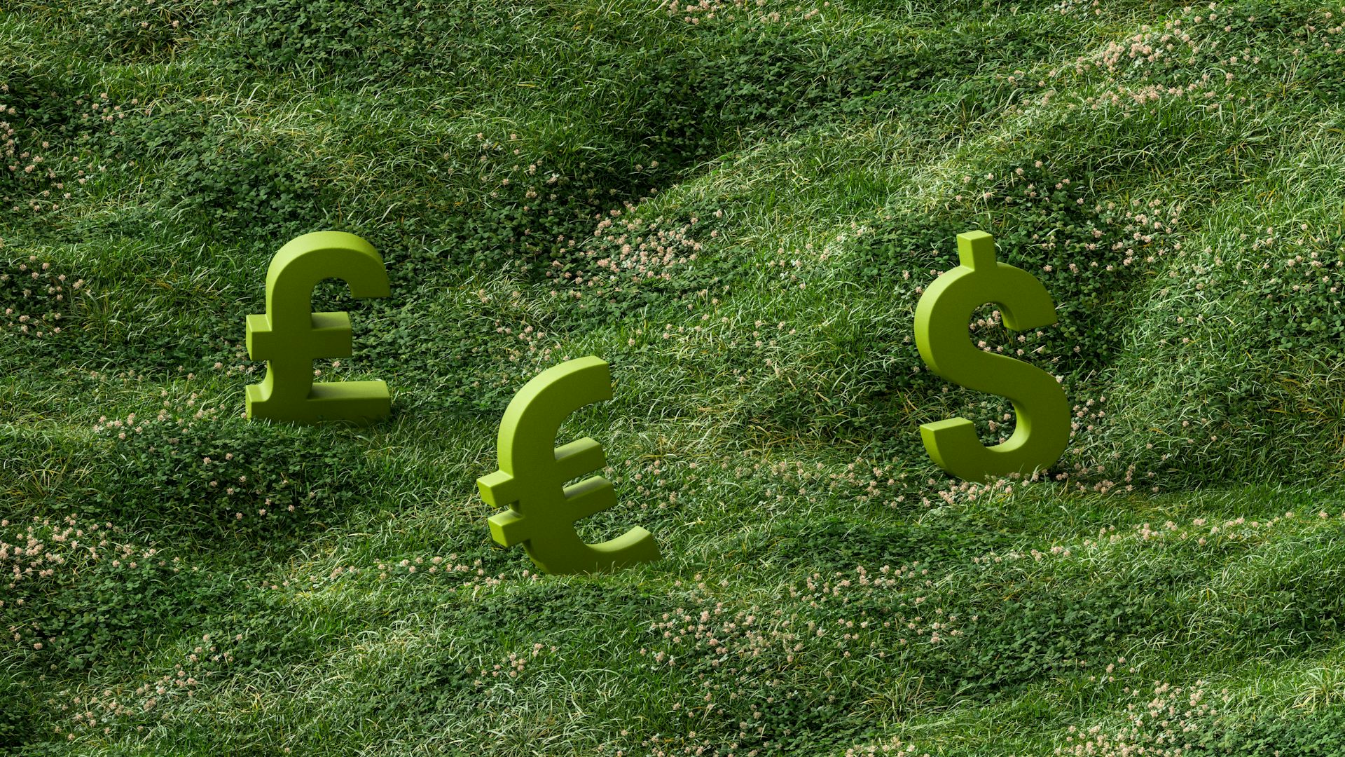 Pound, euro and dollar signs sitting on a grassy hill