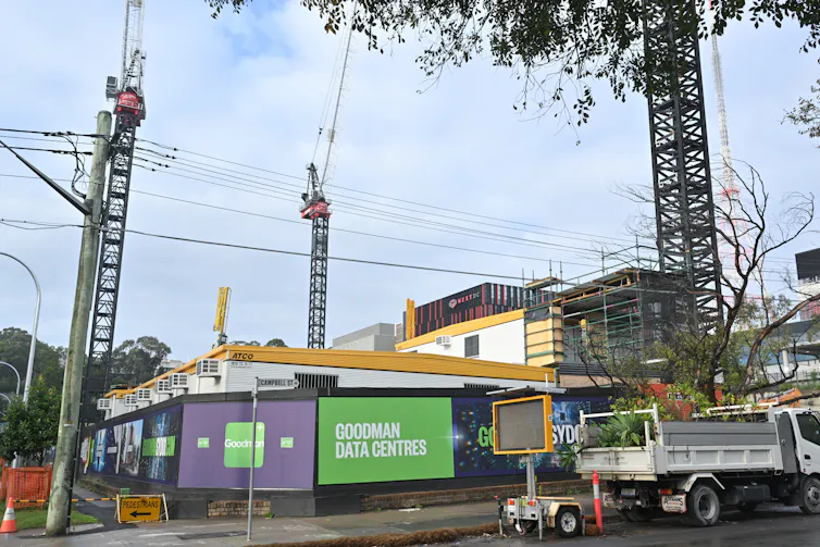 data centre construction site in city, cranes and hoardings.