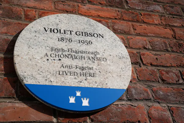 Marble plaque on a brick wall.