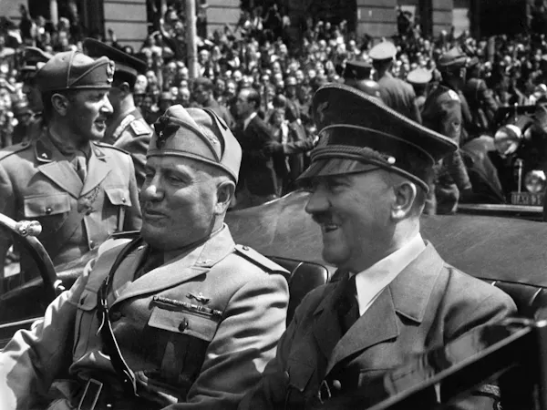 Mussolini with Adolf Hitler in an open top car.