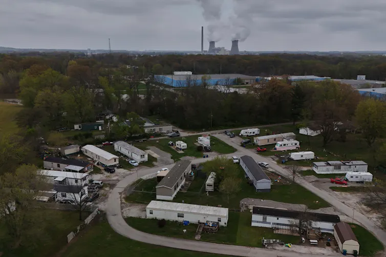 This mobile home community is in a rural area near a power plant.