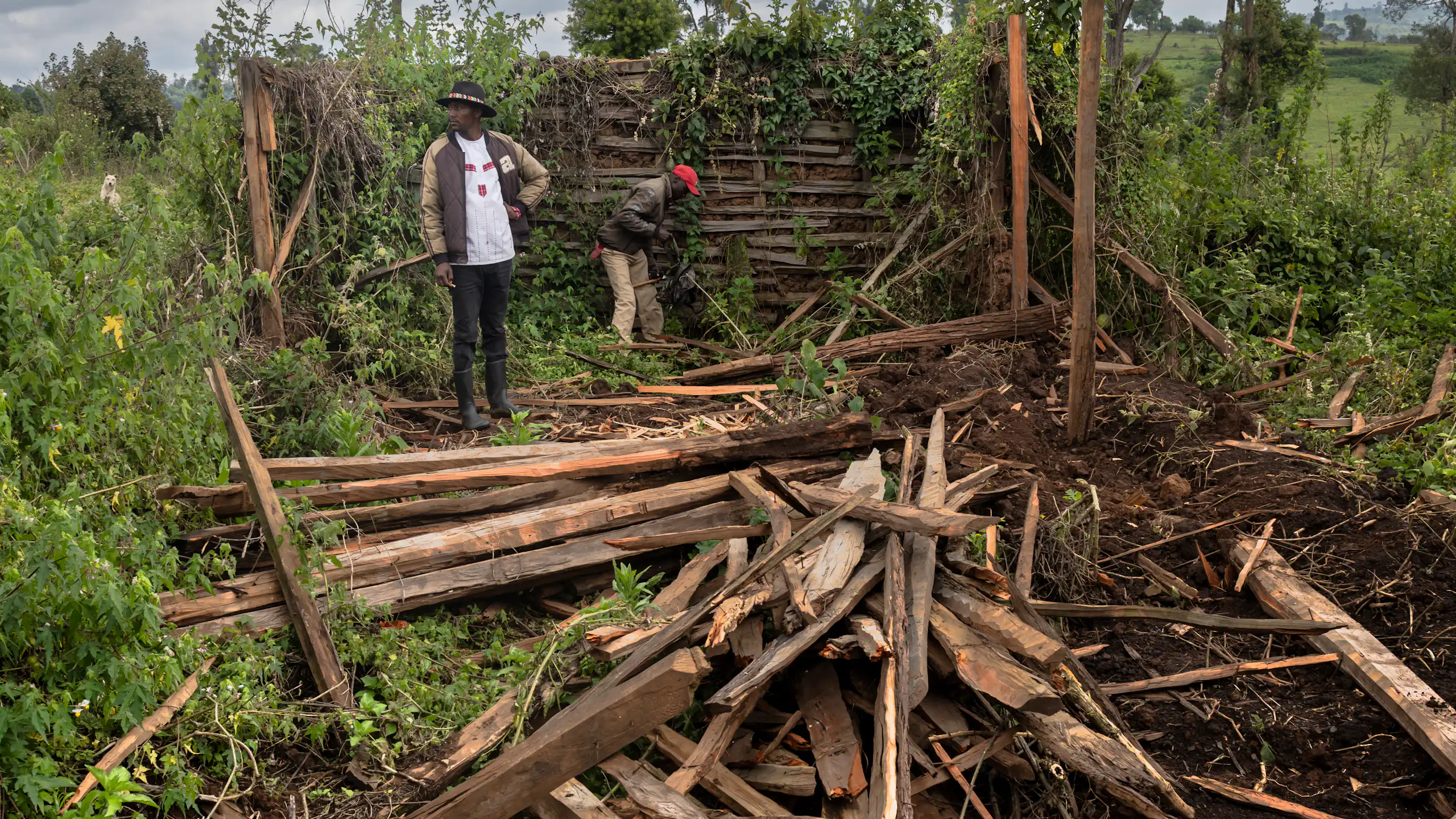 Two people pick through debris left from the destruction of a home.