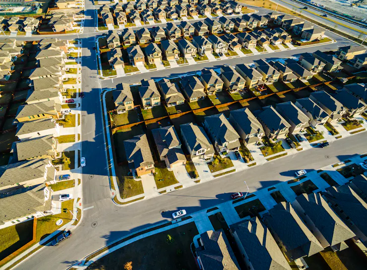 A bird's eye view of identical-looking homes in a suburban development.