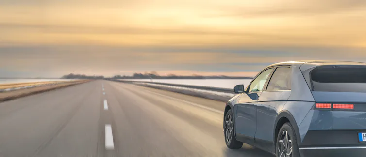 big grey SUV car driving on open road