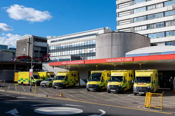 Ambulances and a Welsh Air Ambulance outside the A&E department at the University Hospital of Wales in Cardiff