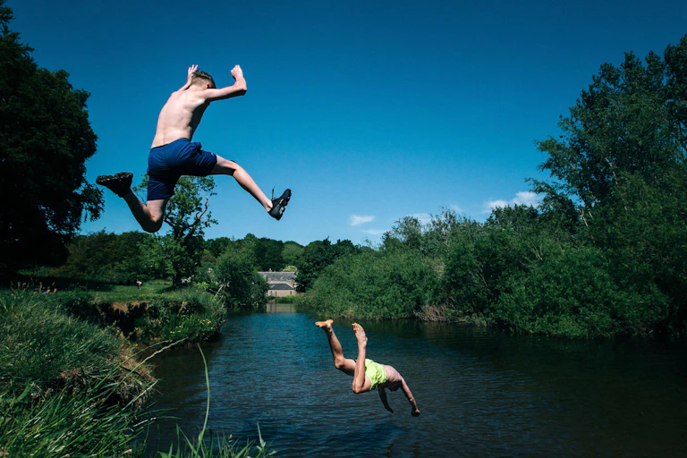 Two teenagers jump into a river in Glasgow, Scotland
