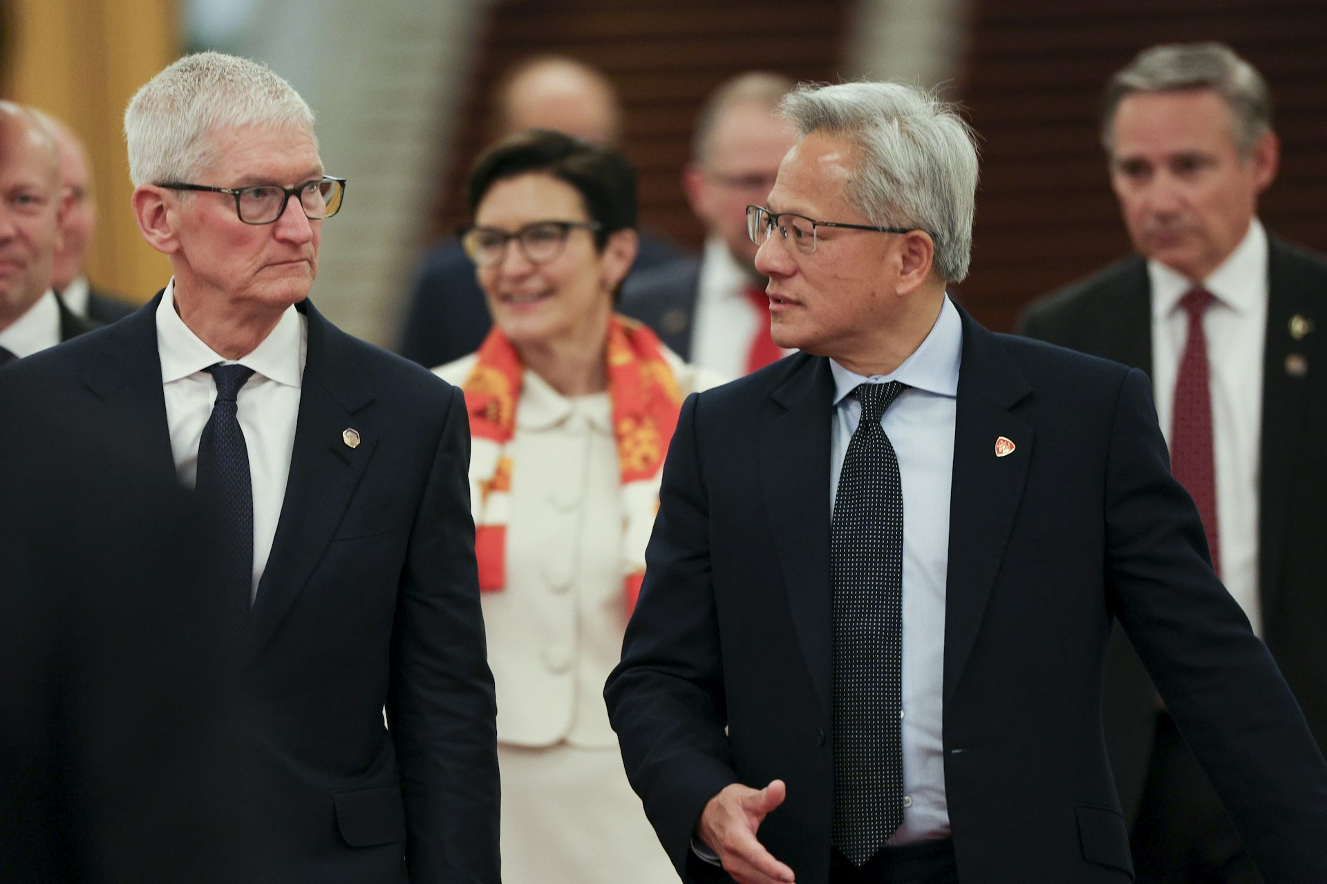 Tim Cook and Jensen Huang arrive for a meeting at the Great Hall of the People in Beijing.