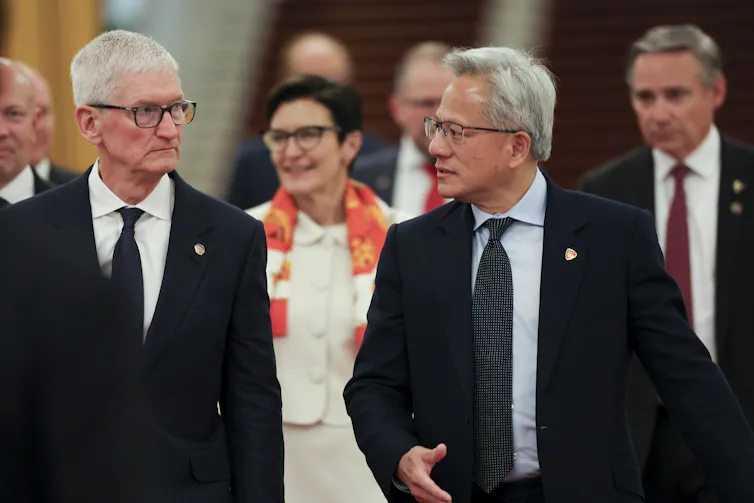 Tim Cook and Jensen Huang arrive for a meeting at the Great Hall of the People in Beijing.