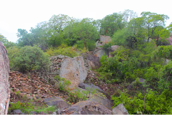 The remains of a wall run along a rocky landscape.