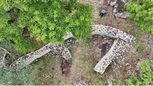An aerial view of stone walls in a leafy landscape.