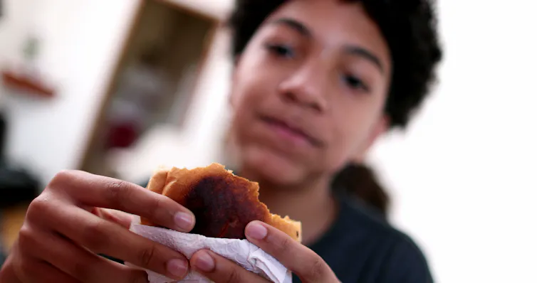 Boy eating sandwich
