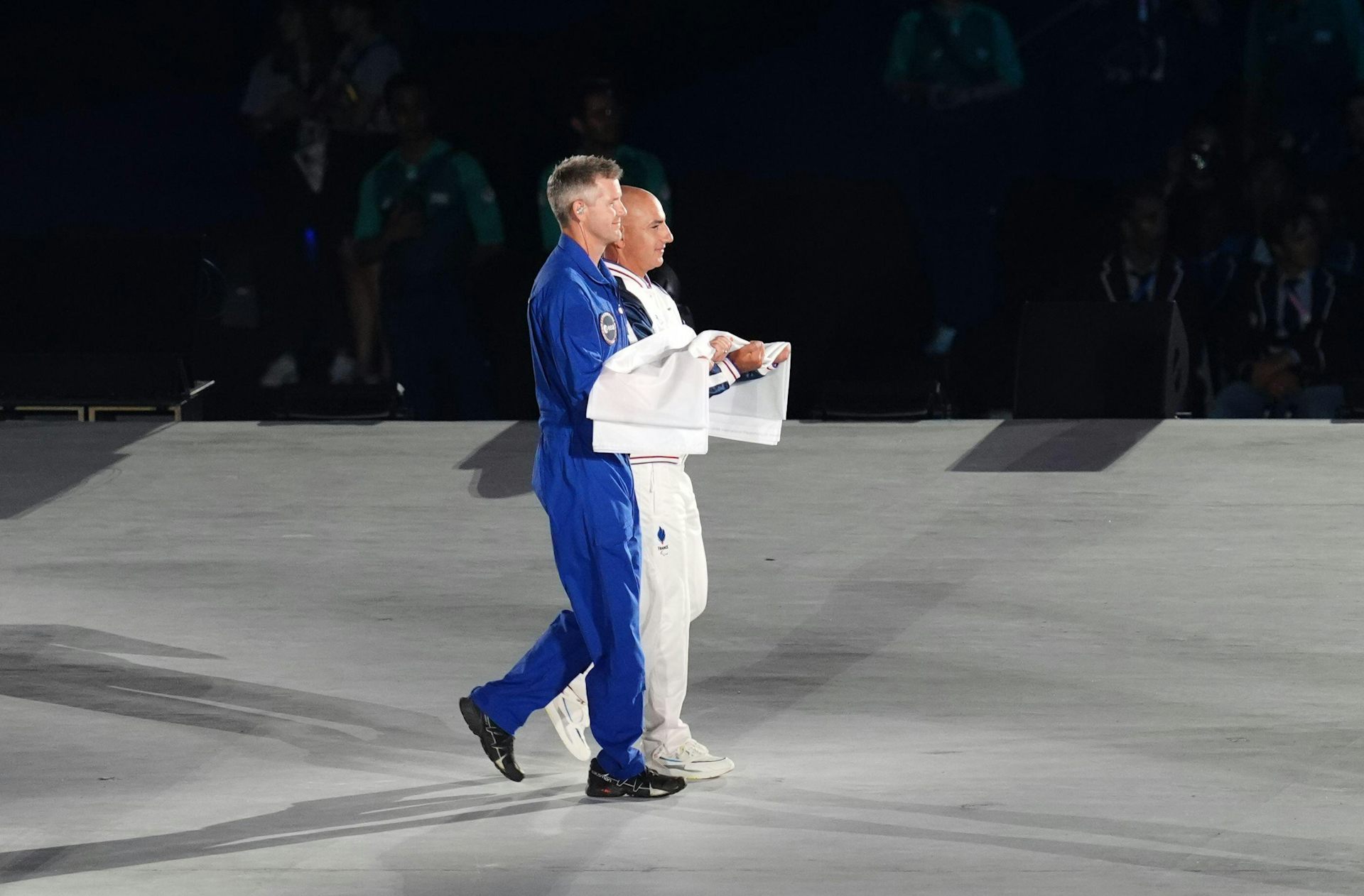 John McFall (in blue) carries the Paralympic flag at the opening ceremony of the Paris 2024 Paralympic Games.