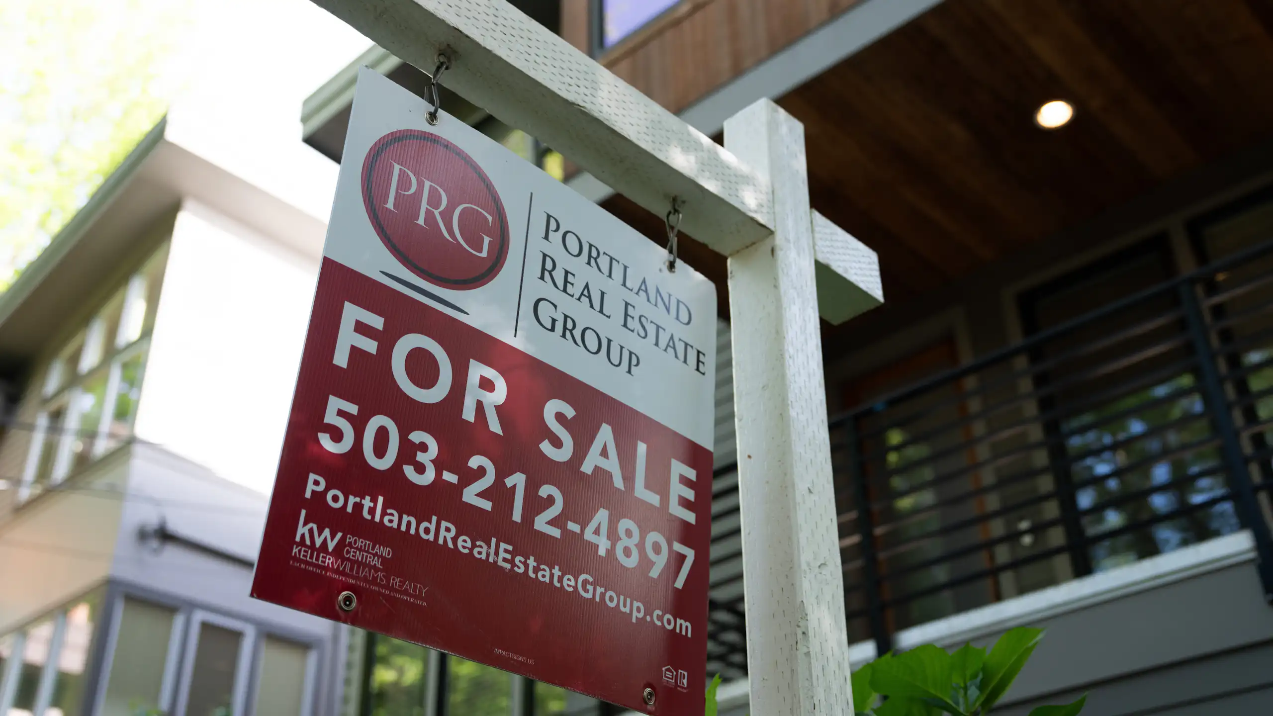 A red and white "for sale" sign is displayed outside a home in Portland, Oregon, on May 12, 2026.