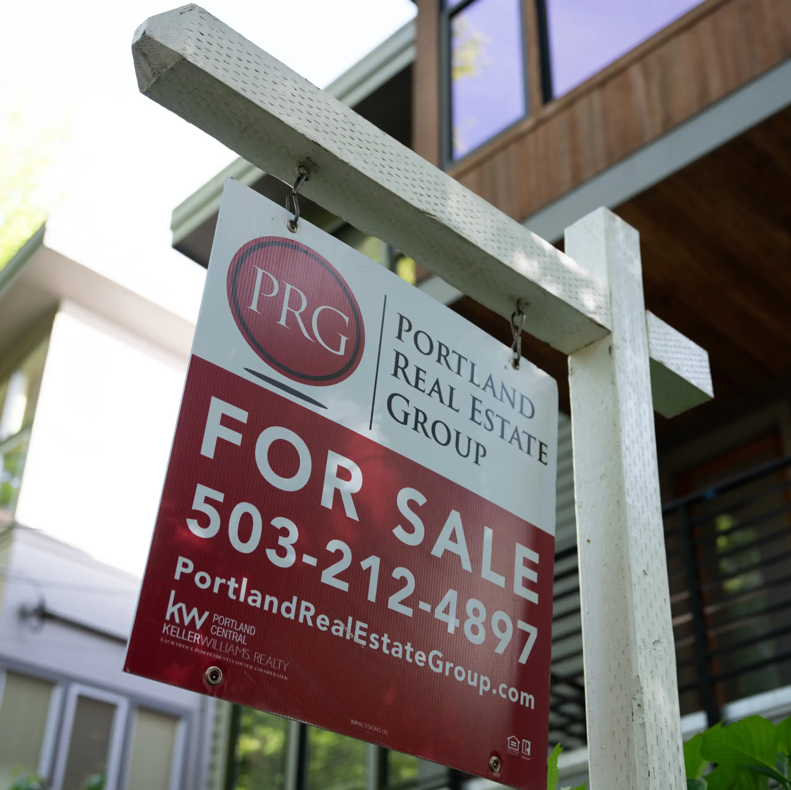 A red and white "for sale" sign is displayed outside a home in Portland, Oregon, on May 12, 2026.