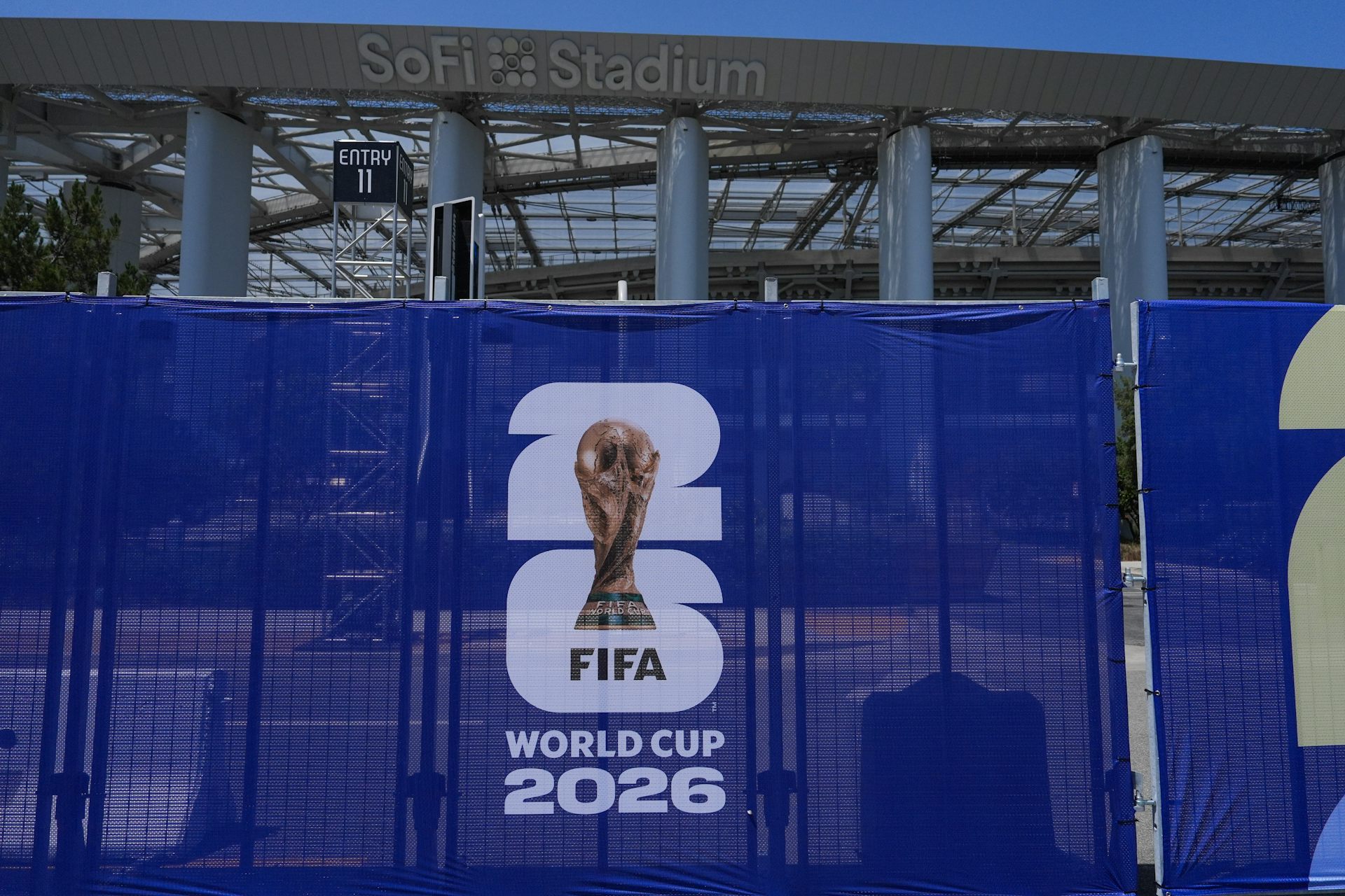 A closeup of the 2026 FIFA World Cup logo on a blue fence